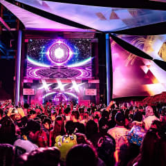 Full stage production with a kaleidoscope LED visual and decorated set above a large crowd