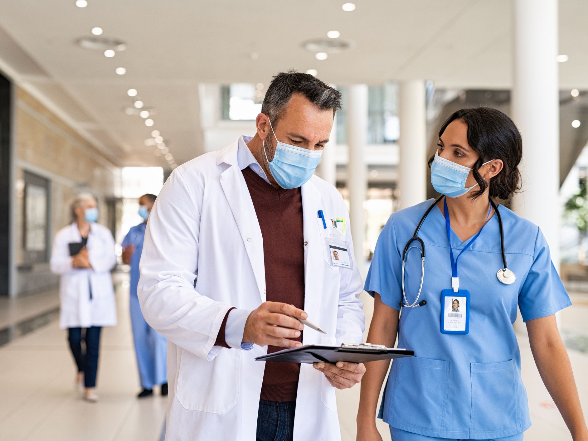 Image of a doctor and nurse talking.