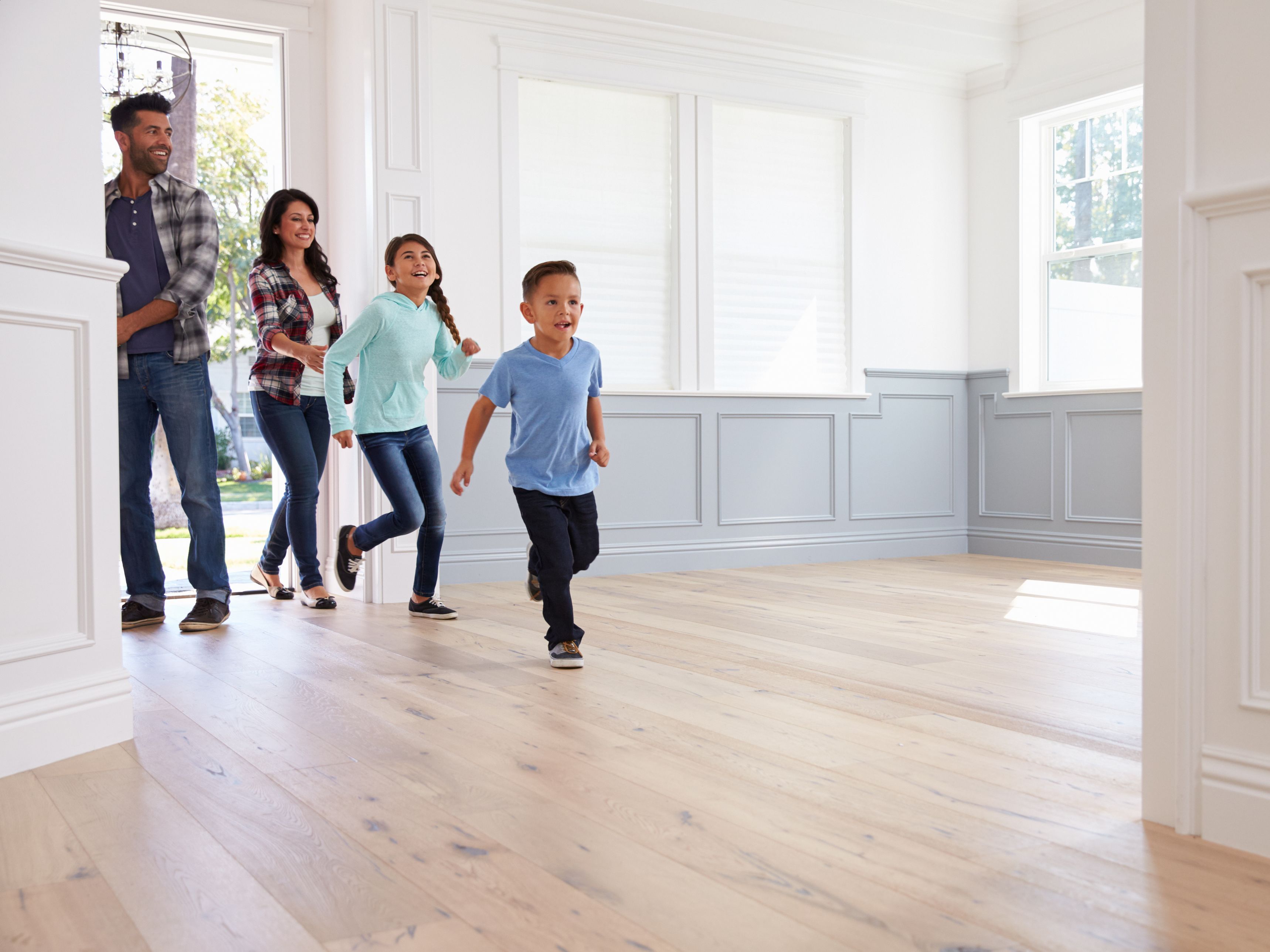 Image of a family walking into a home.