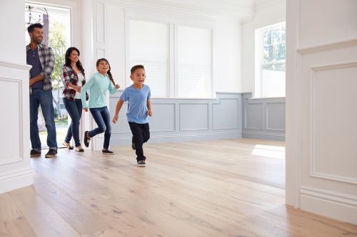 Image of a family walking into a home.