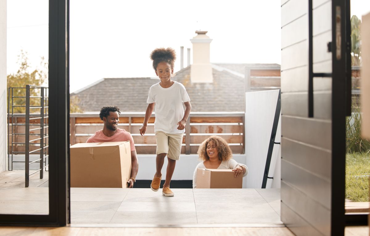 A family of four walks into their newly built home.