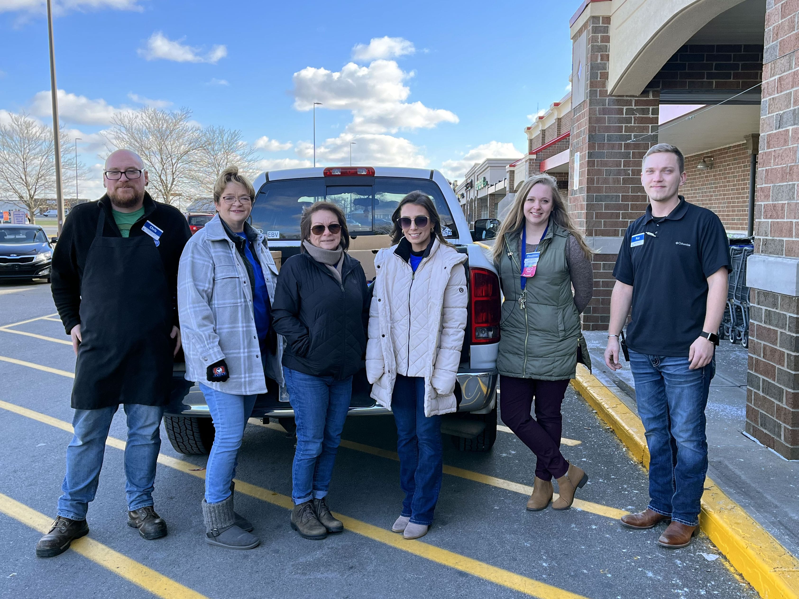 Employees in the Knauf Cares Program purchasing groceries for families in need.
