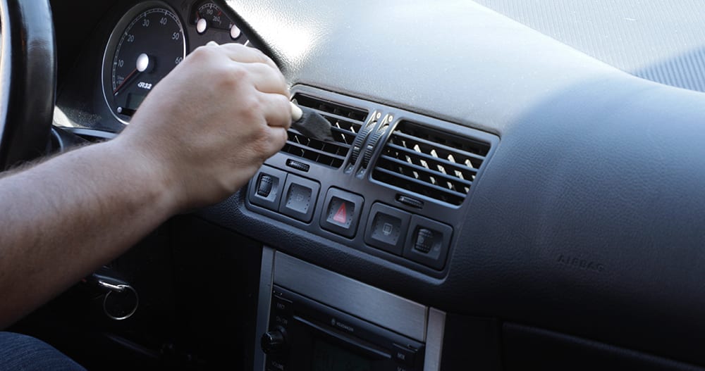 Cleaning cabin vents with a foam brush