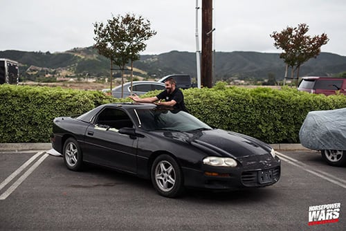 Man with a black vehicle