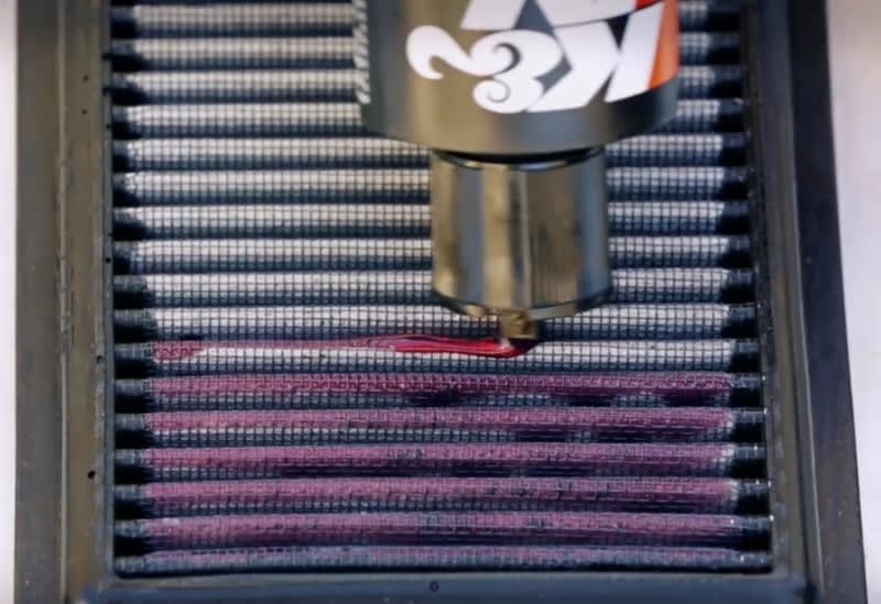 Applying K&N filter oil from a squeeze bottle Applying K&N filter oil from a squeeze bottle