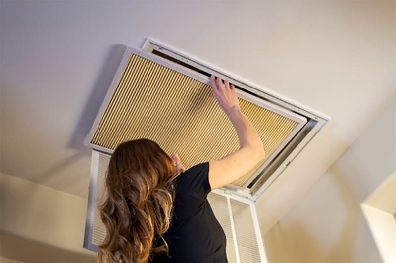 Woman installing K&N home air filter