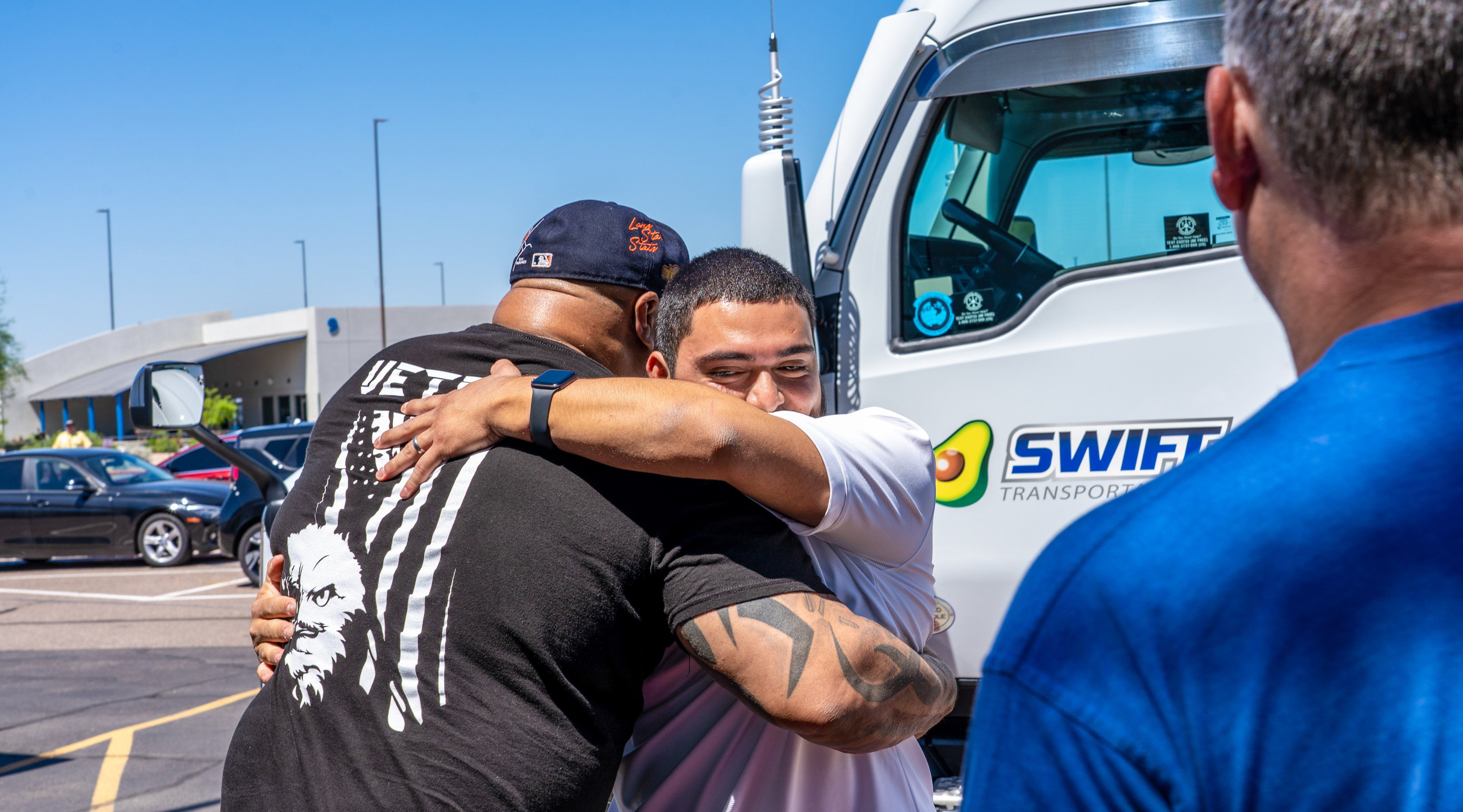 Swift Transportation employees hugging each other.