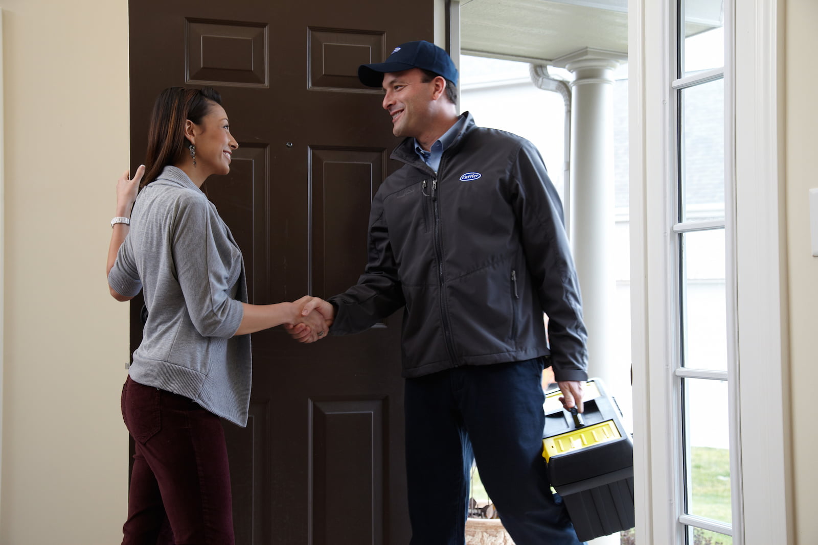 Bryant technician showing a couple their new air conditioner