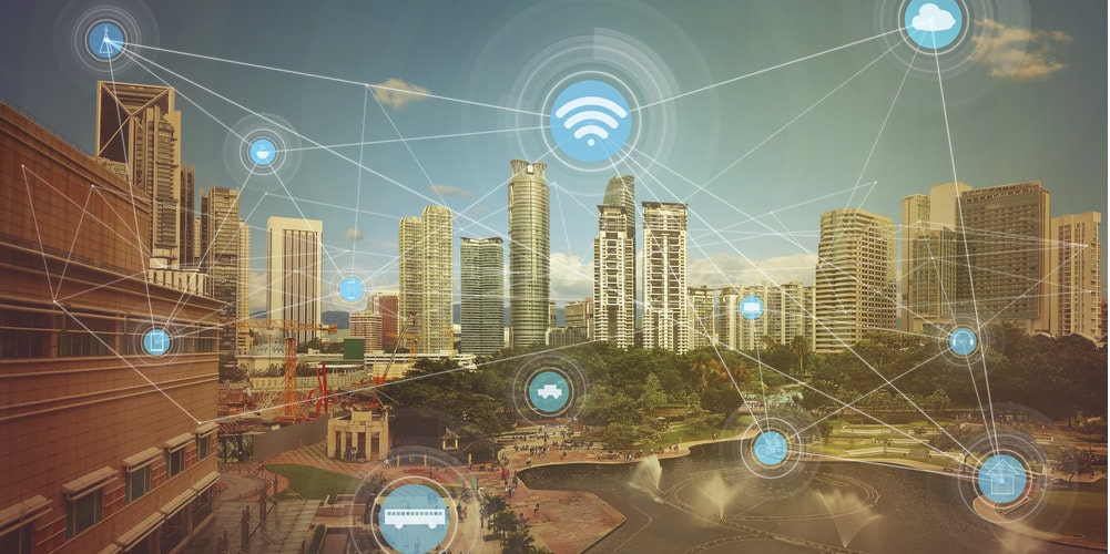 a city with skyscrapers with different blue bubble symbols interconnected such as wifi, cloud, home, bike and further