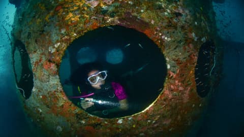 Koh Tao Divers student exploring the inside of a large shipwreck opening