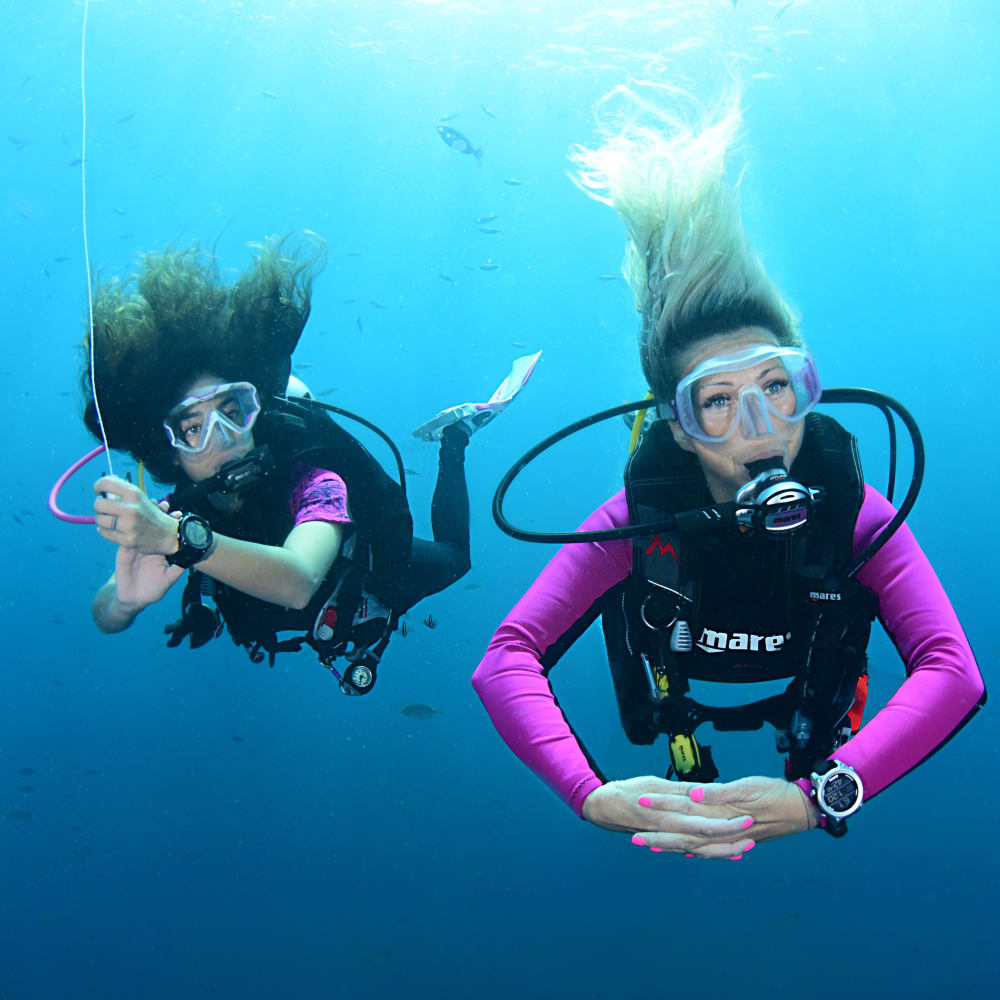 Koh Tao Divers two female scuba divers practicing buoyancy control underwater