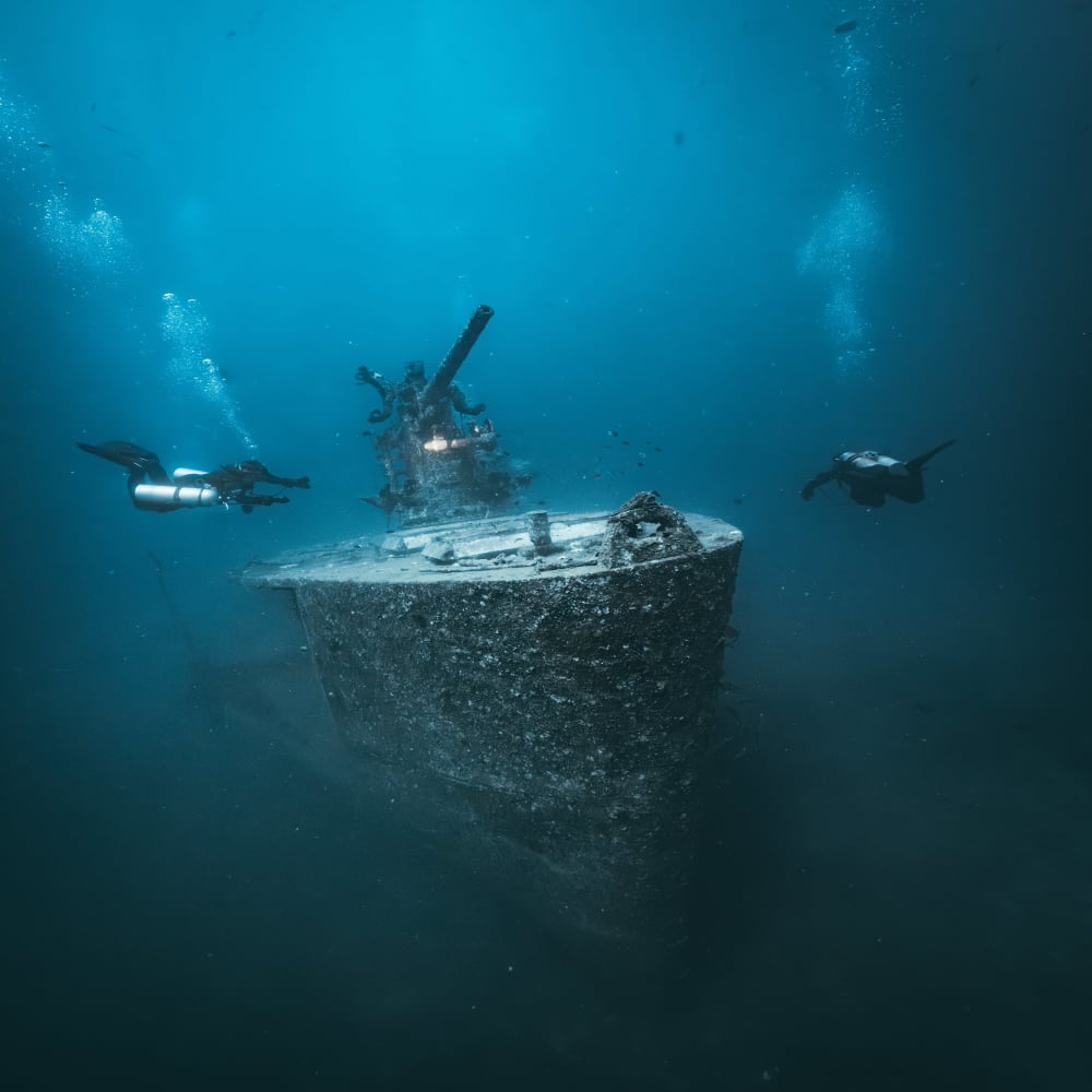 Koh Tao Divers technical divers examining details of a shipwreck floor during a deep dive