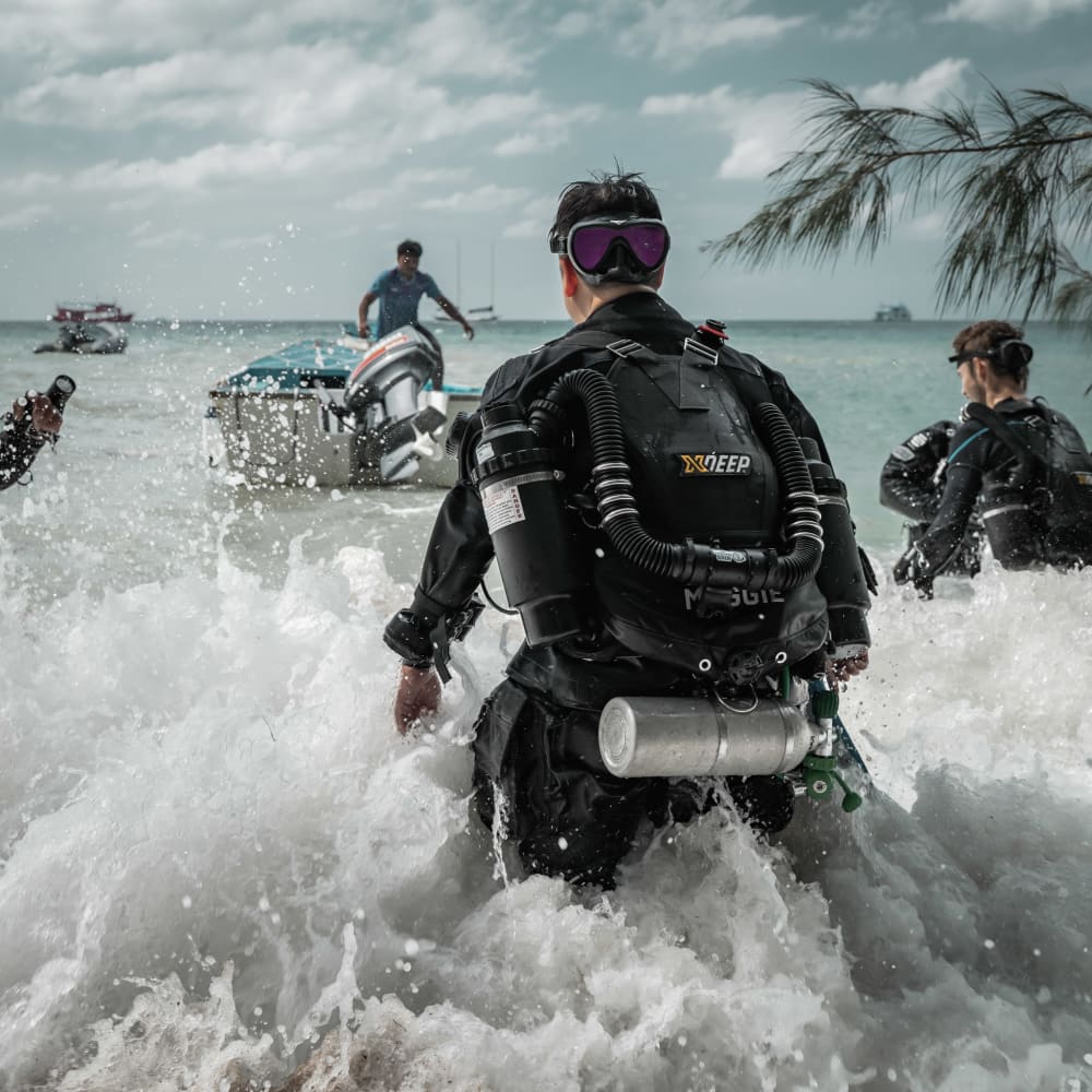 Koh tao divers CCR divers walking to a boat with swells