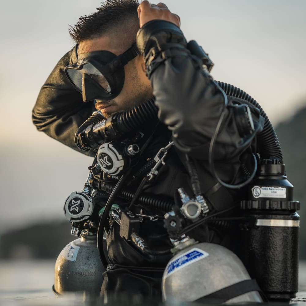 Koh Tao Divers rebreather divers entering the sea preparing for a deep CCR dive from the beach