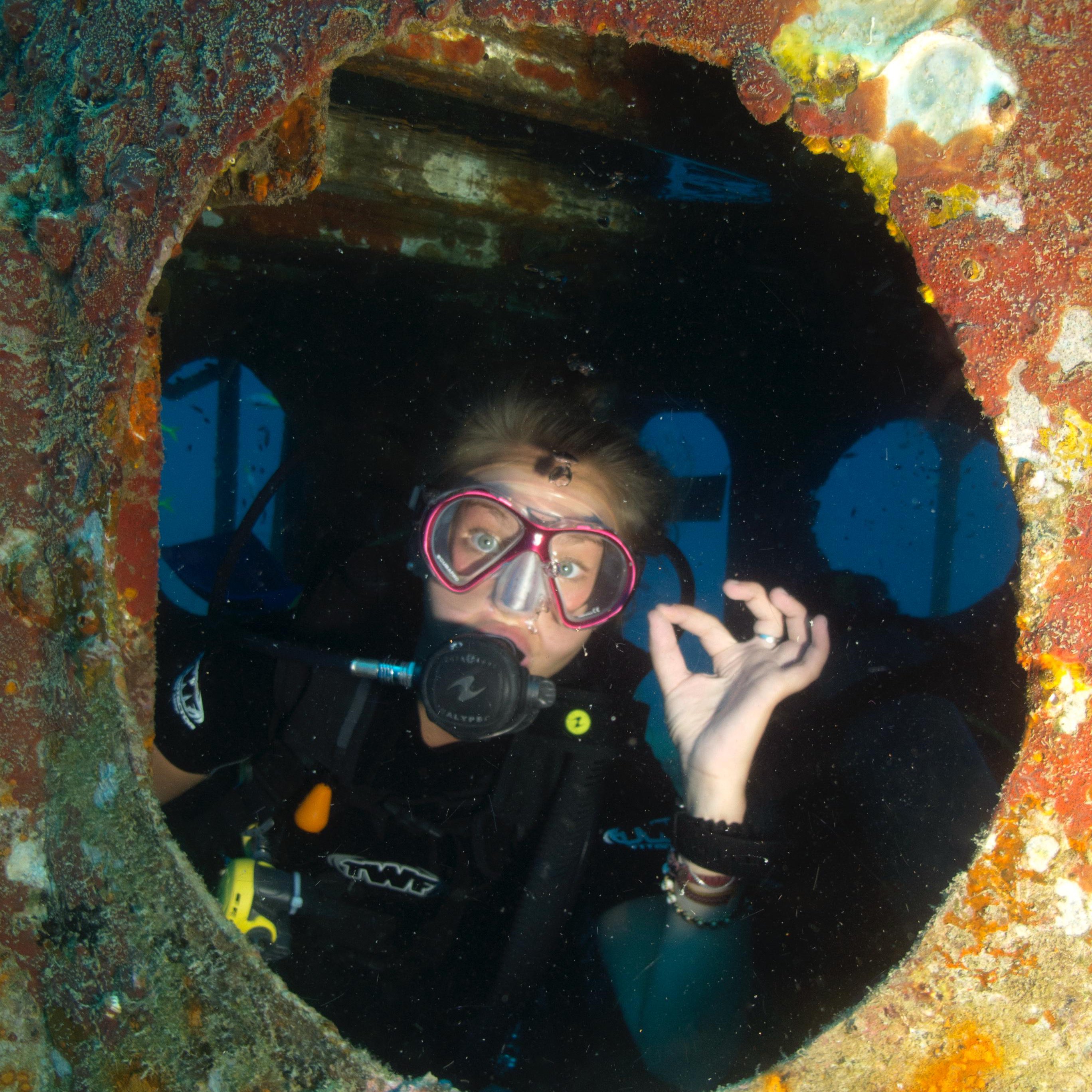 Koh tao divers diver exploring the interior of a sunken wreck