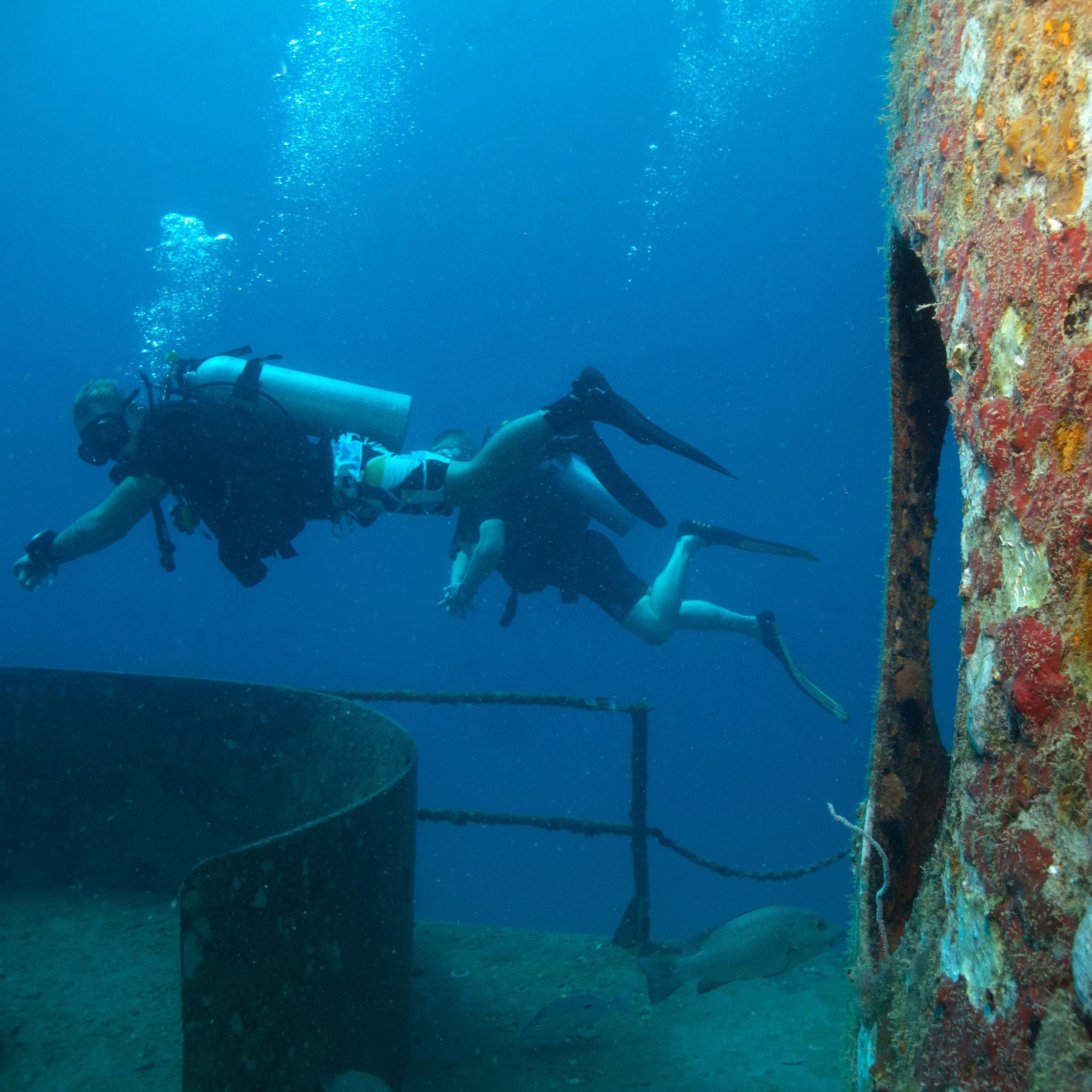 Koh Tao Divers diver examining the structure of a submerged military vessel