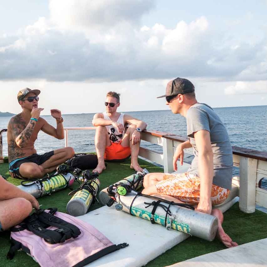 Koh Tao Divers  Divemaster keep briefing to divers on the sun deck.