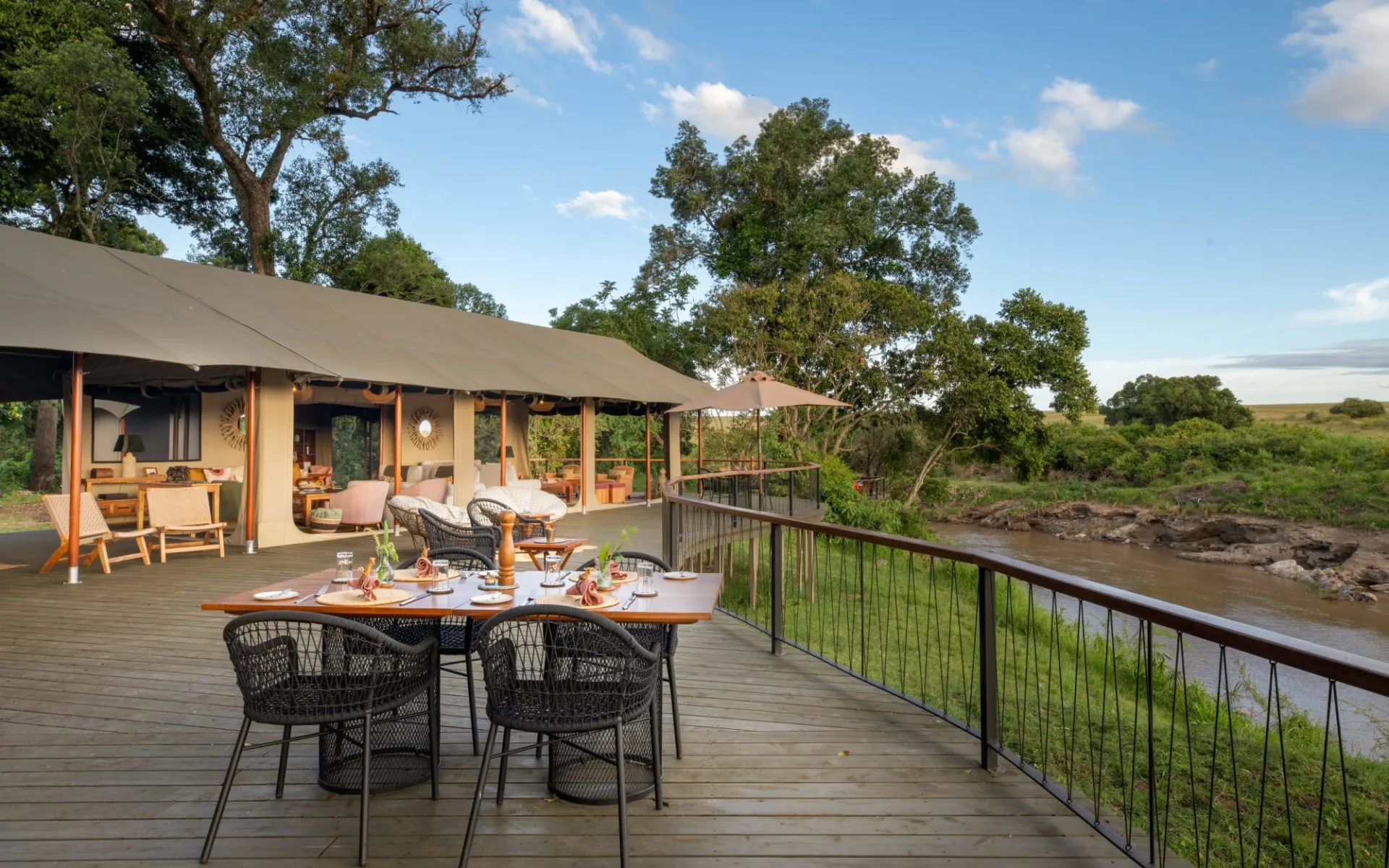 Rekero Camp in Masai Mara:  Communal Dining Setup on Deck with river view