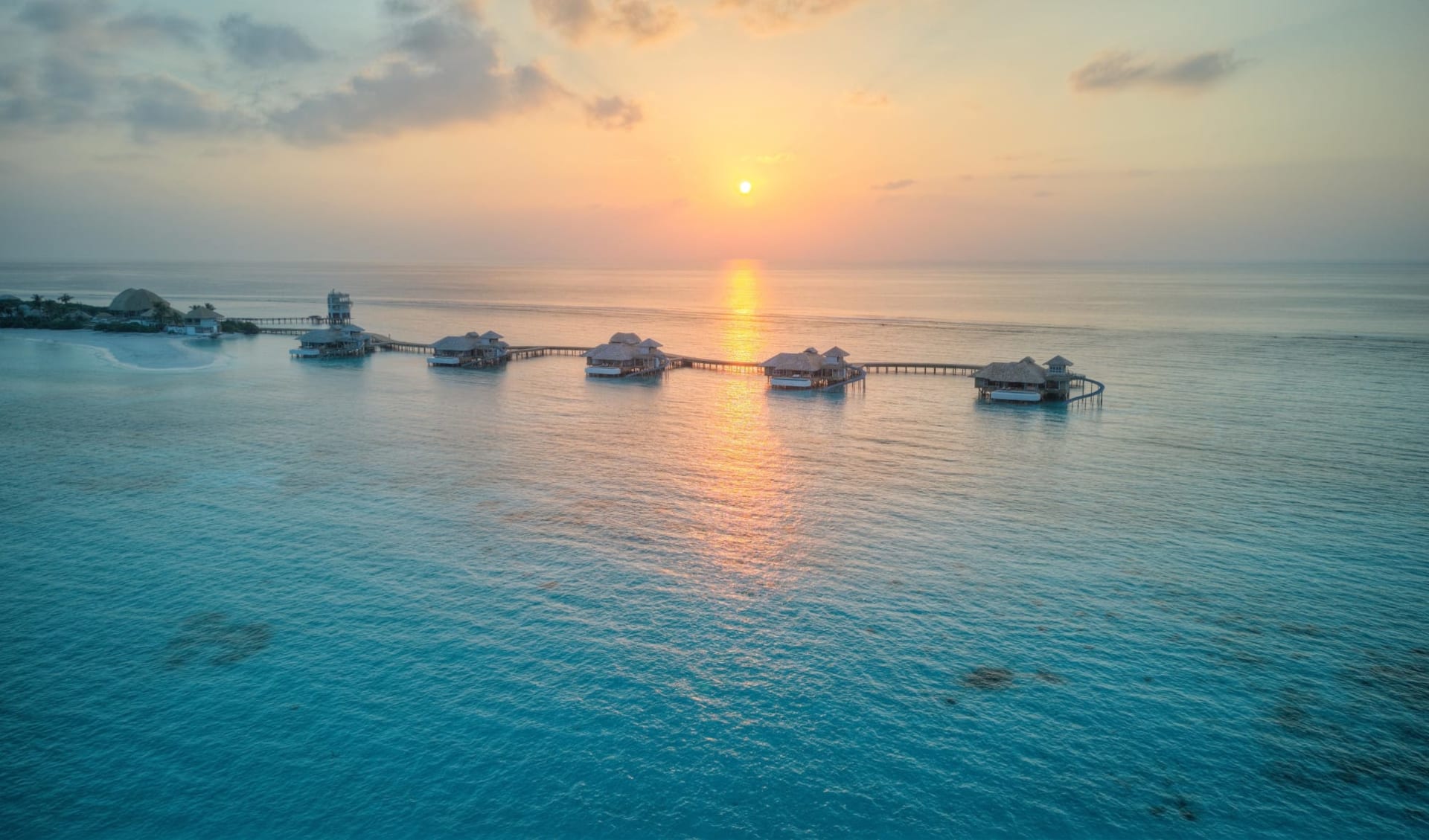 Soneva Secret in Haa-Dhaalu-Atoll:  Overwater Hideaway Aerial View at Sunset