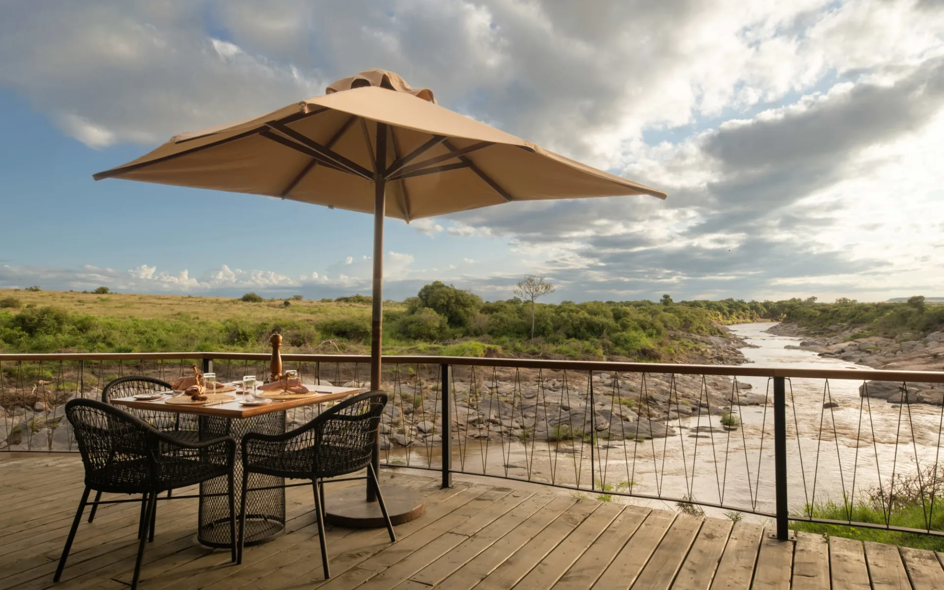 Rekero Camp in Masai Mara: Seating on Deck with view of the river Rekero Camp in Masai Mara: Seating on Deck with view of the river