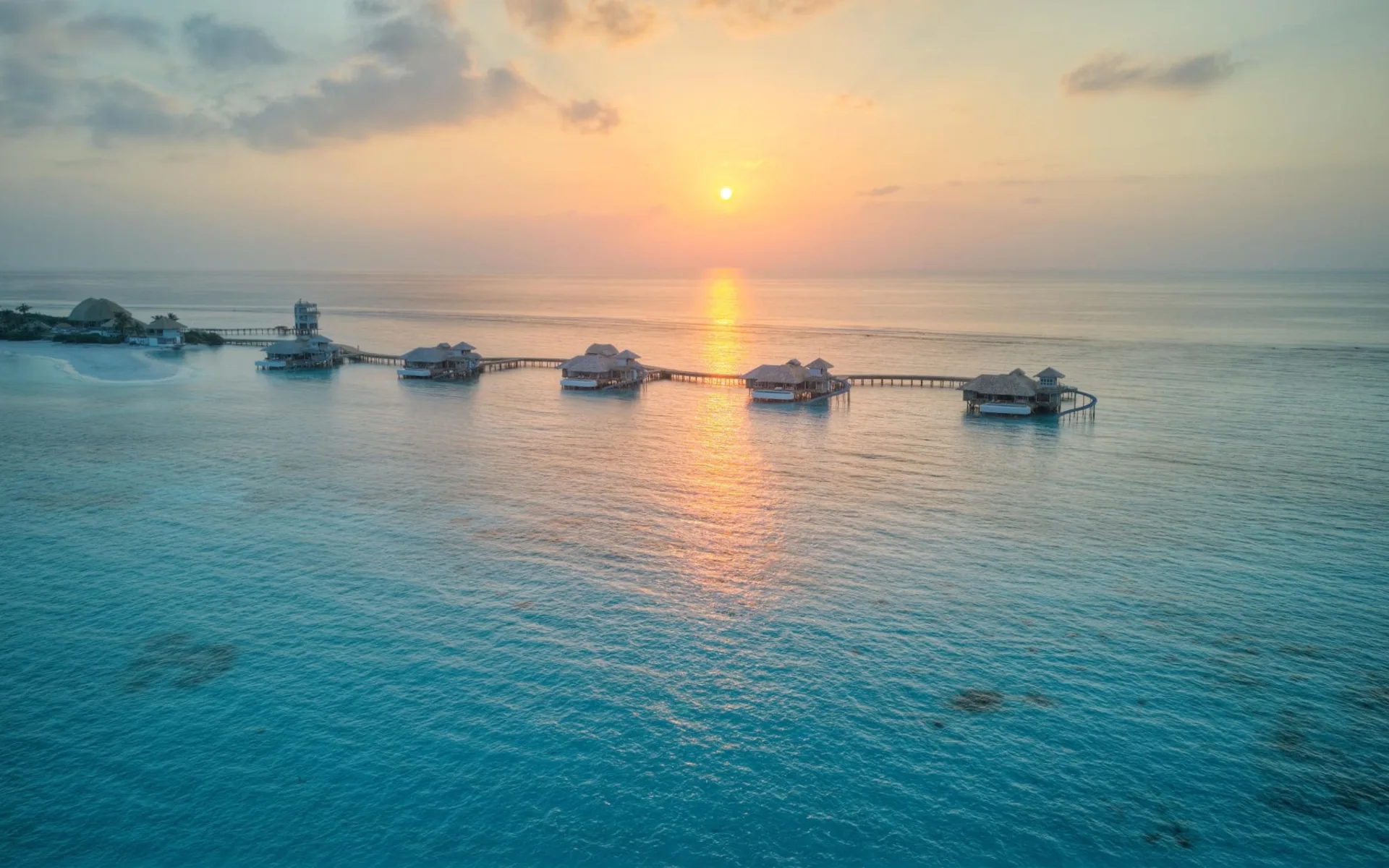 Soneva Secret in Haa-Dhaalu-Atoll: Overwater Hideaway Aerial View at Sunset Soneva Secret in Haa-Dhaalu-Atoll: Overwater Hideaway Aerial View at Sunset