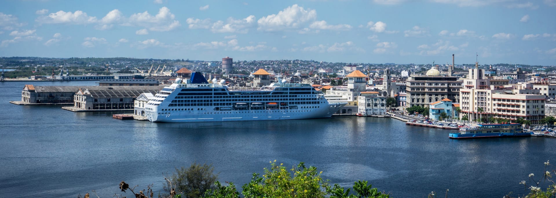 Sunset view from the Castillo De Los Tres Reyes Del Morro. A cruise ship sails from the Havana harbor.