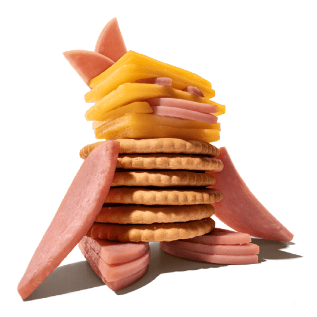 Une création Lunchables ressemblant à un pingouin, faite de craquelins, de tranches de fromage et de jambon.