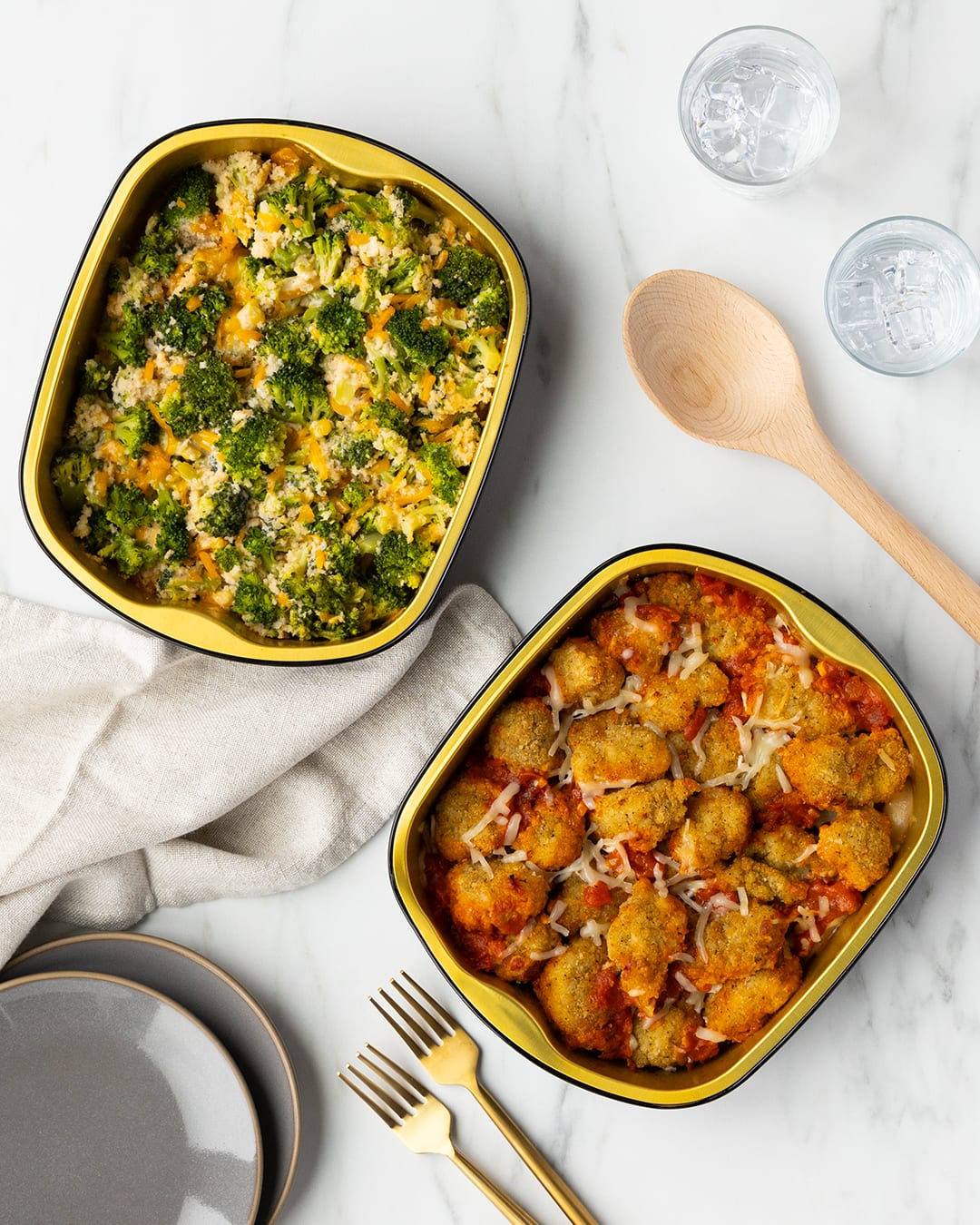 Photo of chicken parmesan and cheesy broccoli on a table