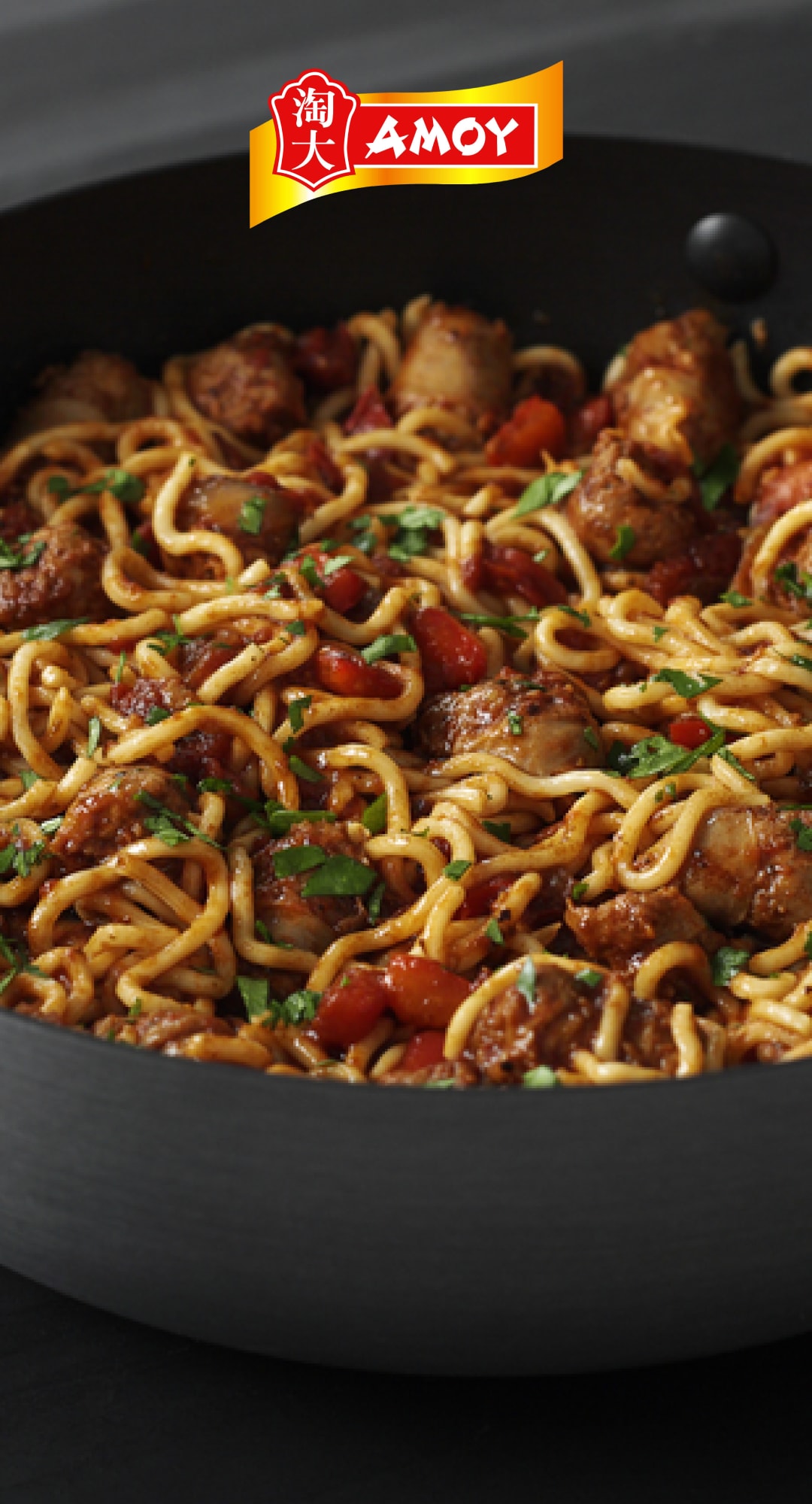 A deep pan full of saucy noodles and meatballs.