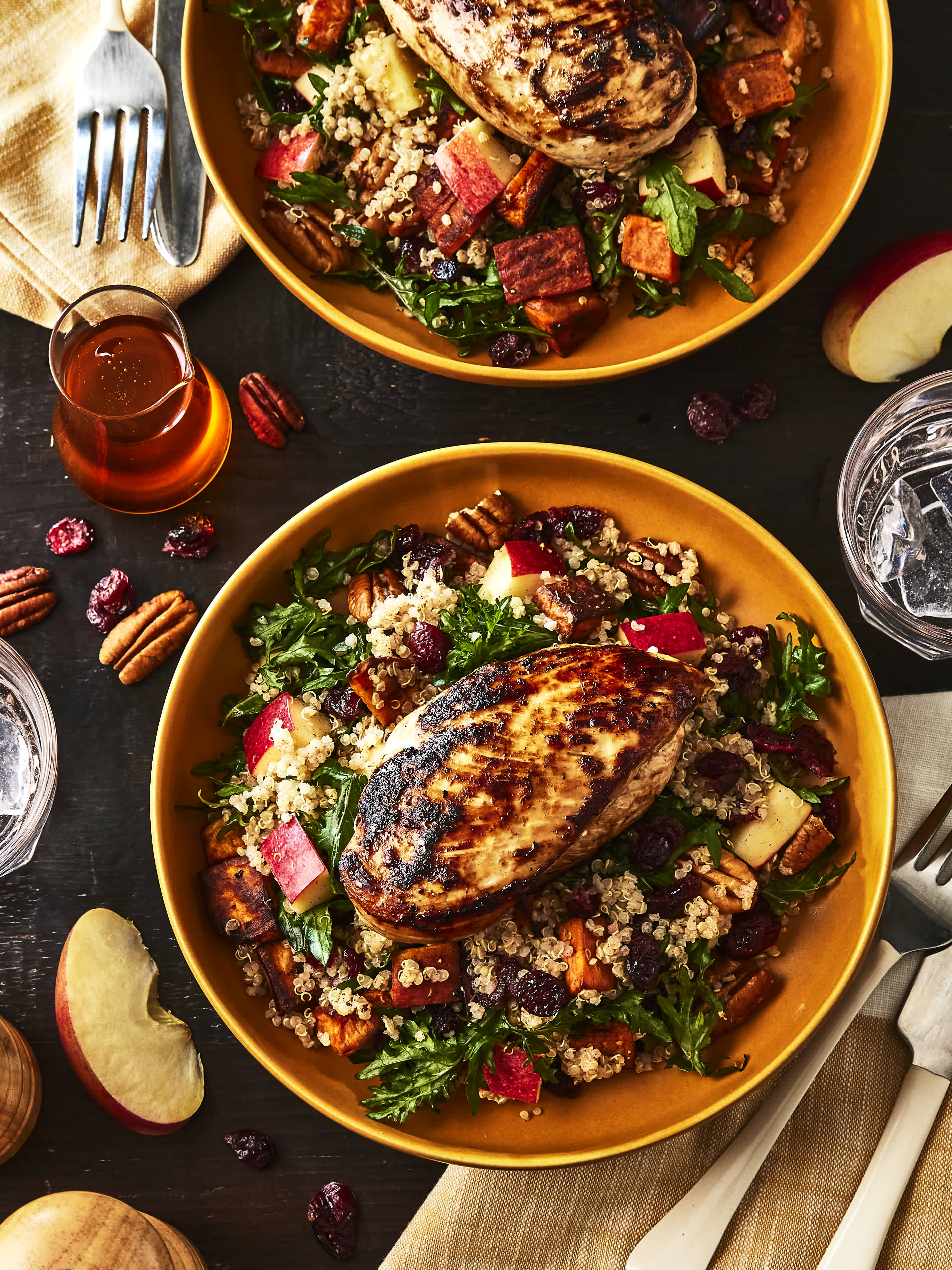 A beautiful dinner table with a Maple Dijon Fall Harvest Power Bowl, which is made with Pure by J.L. Kraft Dressings.