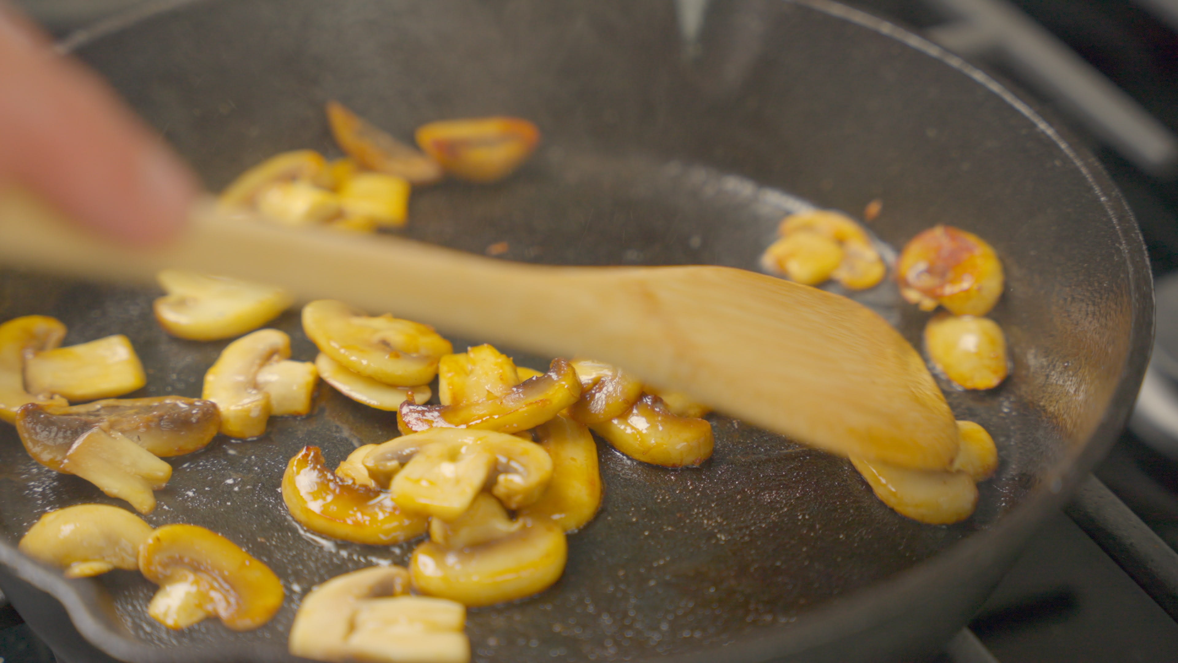 Mushrooms frying over medium heat in a large skilled for 3-4 minutes until cooked.