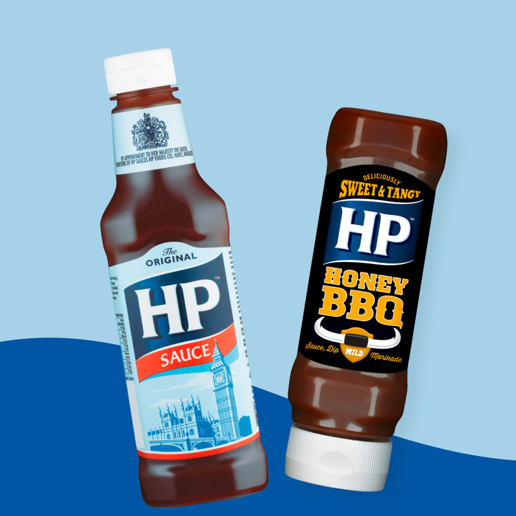 A bottle of Original HP Sauce and a bottle of HP Honey BBQ in front of a blue background.