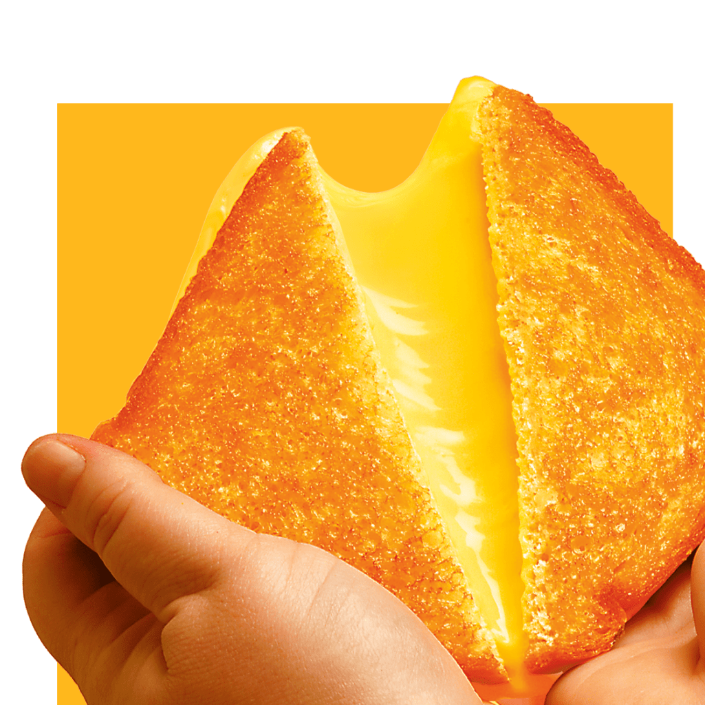 A grilled cheese sandwich being held, with melted cheese being pulled.