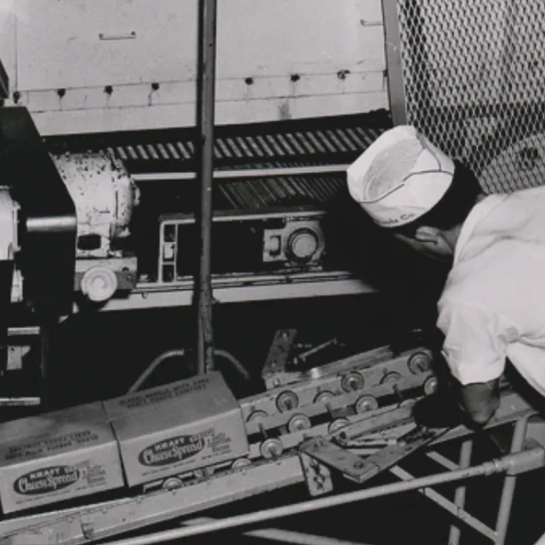 A man loads boxes on a factory rolling line