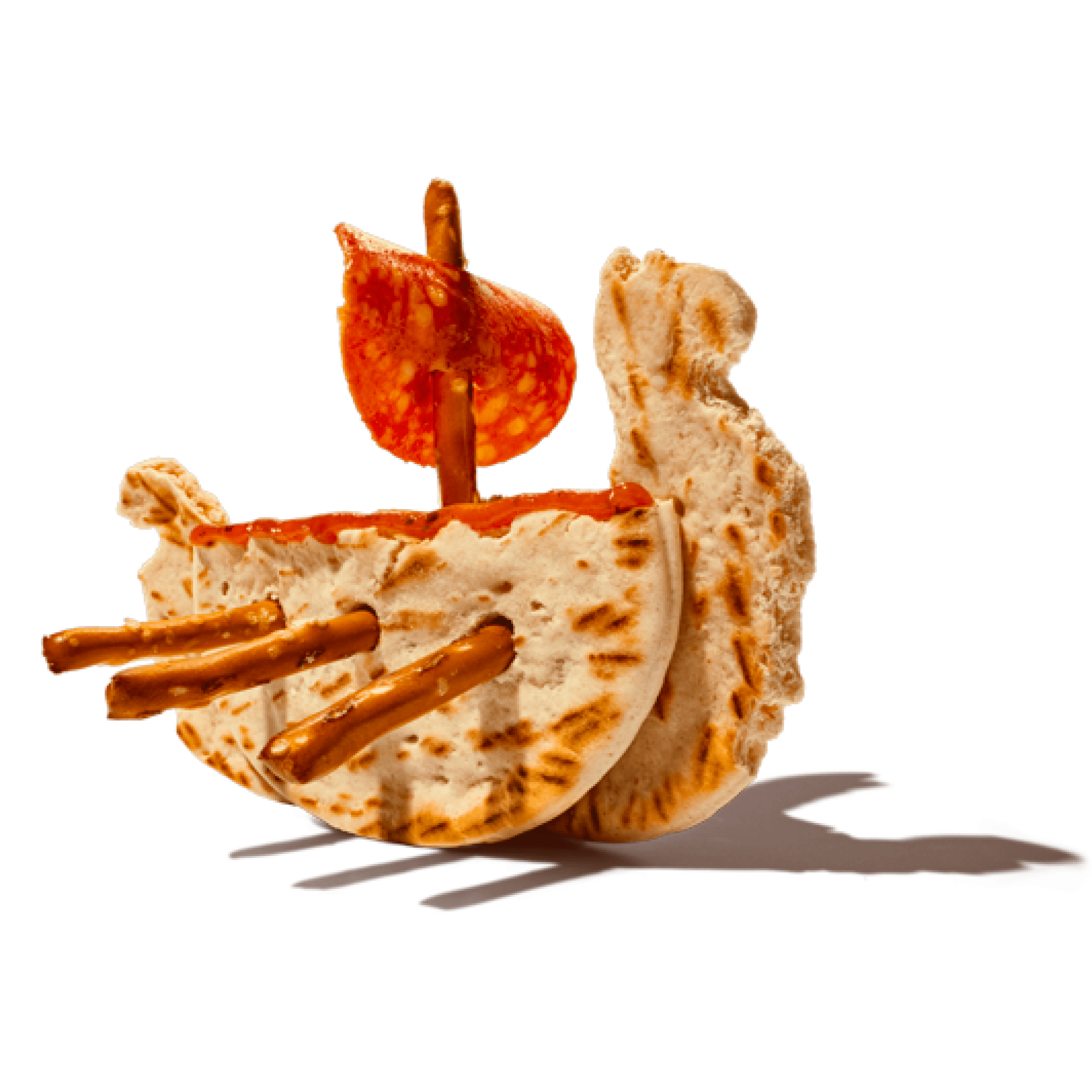Pita bread boat with pretzel stick oars and pepperoni sail.