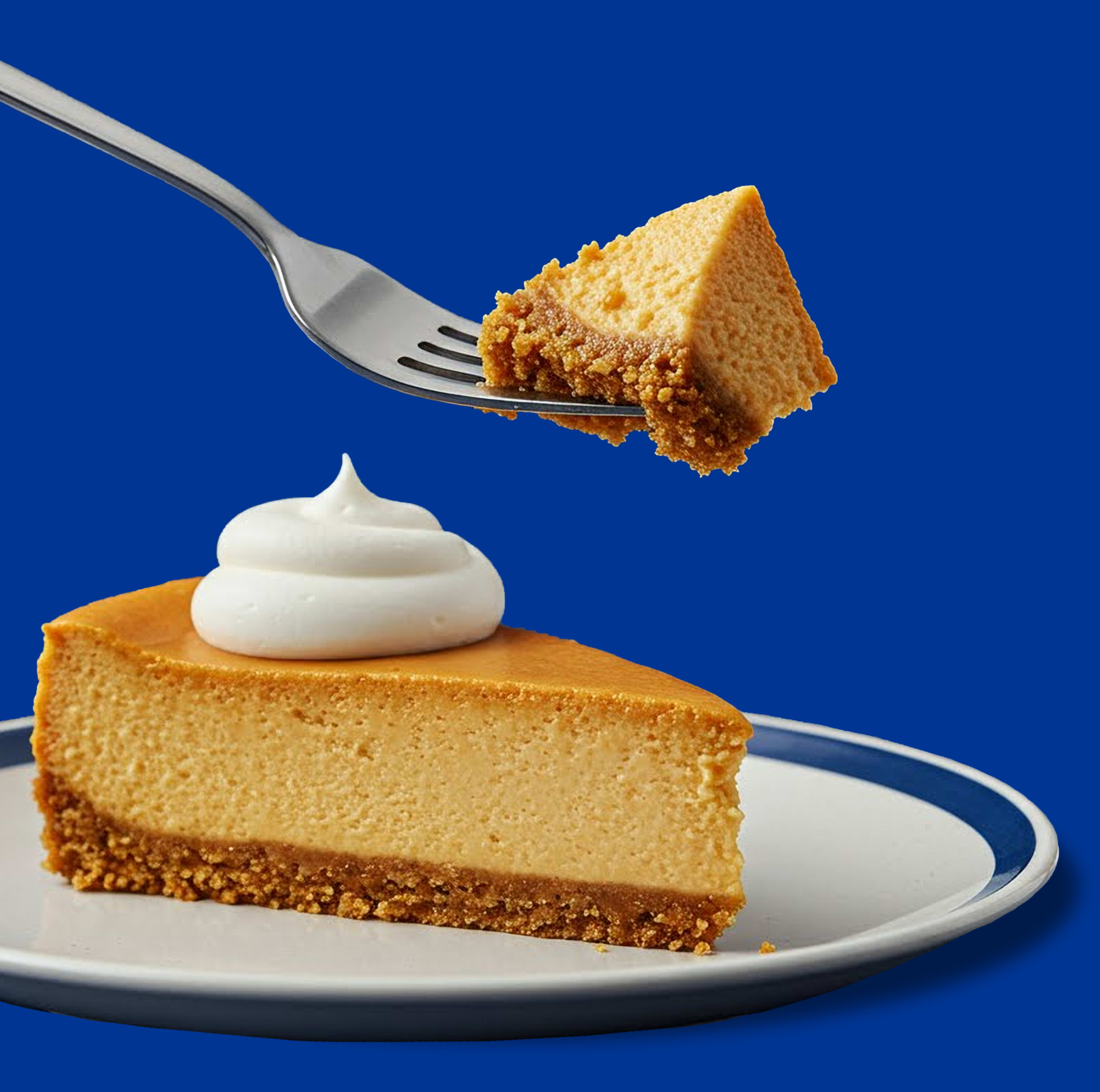 Philadelphia cheesecake slice with whipped cream on a plate. Fork lifts a bite, showing creamy texture & crust.