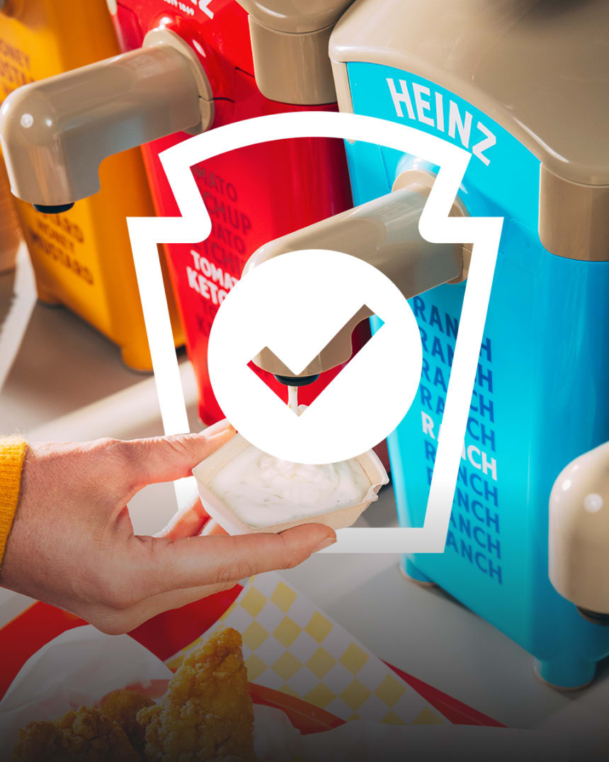 A close-up shot shows a hand dispensing ranch dressing from a Heinz sauce dispenser into a small paper cup. In the foreground