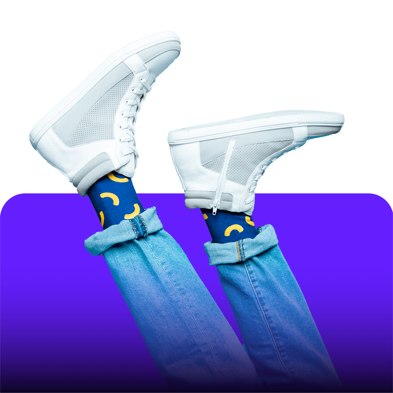 A person wearing blue jeans and socks with macaroni and cheese pattern on them, paired with white sneakers.