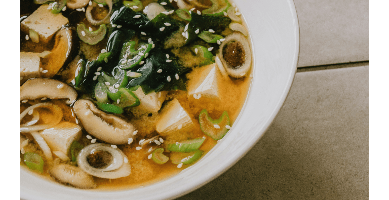 Miso soup with tofu, seaweed, and mushrooms.