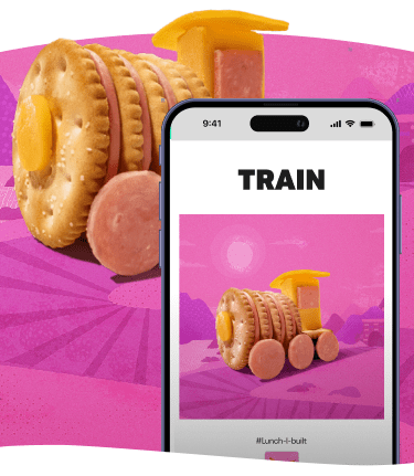 A food train made of crackers, cheese, and sausage, next to a phone displaying the same image.