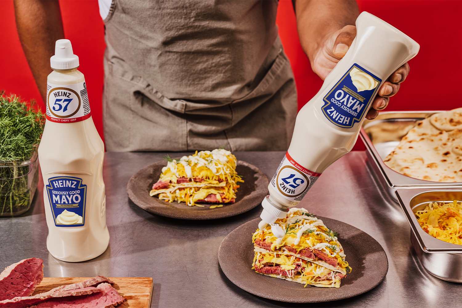 Chef drizzling Heinz Seriously Good Mayo in new Heinz 1L bottle on a quesadilla stack.