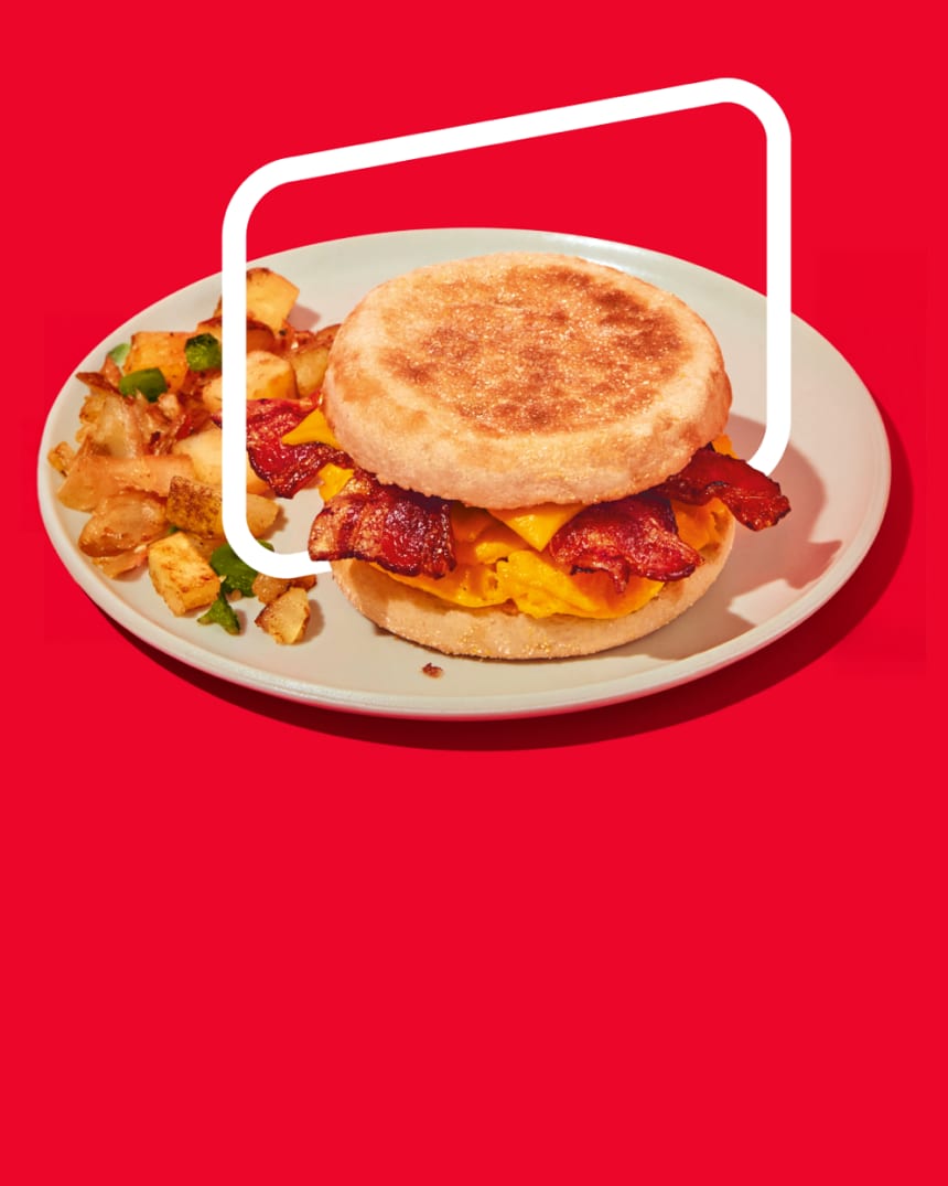 An appetizing Oscar Mayer breakfast sandwich featuring an English muffin, egg, cheese, and bacon, accompanied by seasoned pot