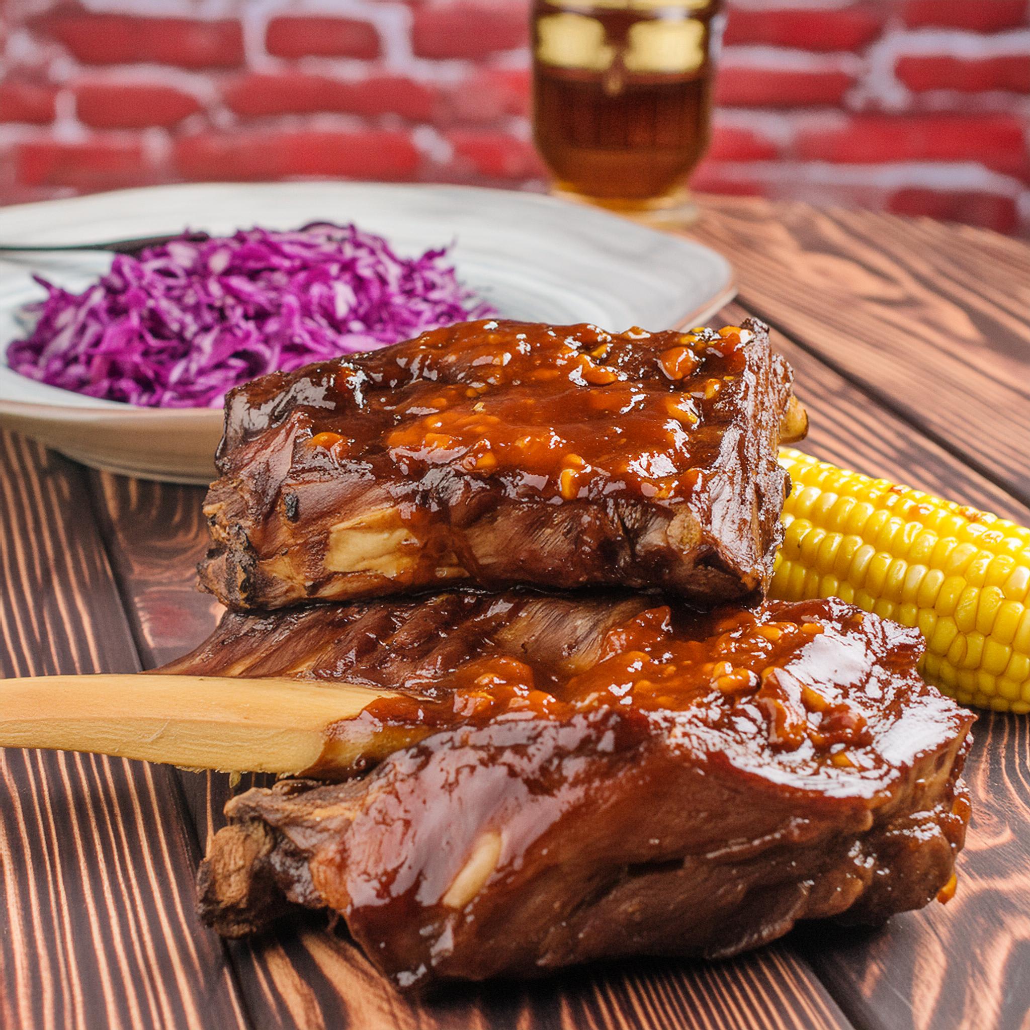 Stacked, sticky glazed beef ribs served with corn on the cob and purple slaw.