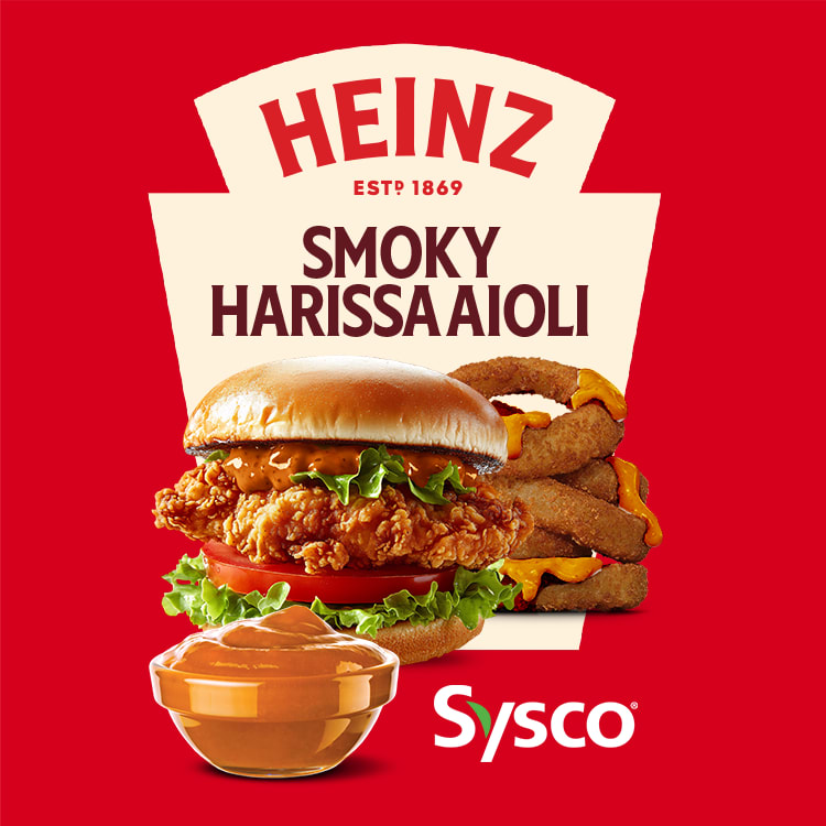Appetizing chicken sandwich and onion rings with Heinz Smoky Harissa Aioli. Heinz and Sysco logos on a red background.