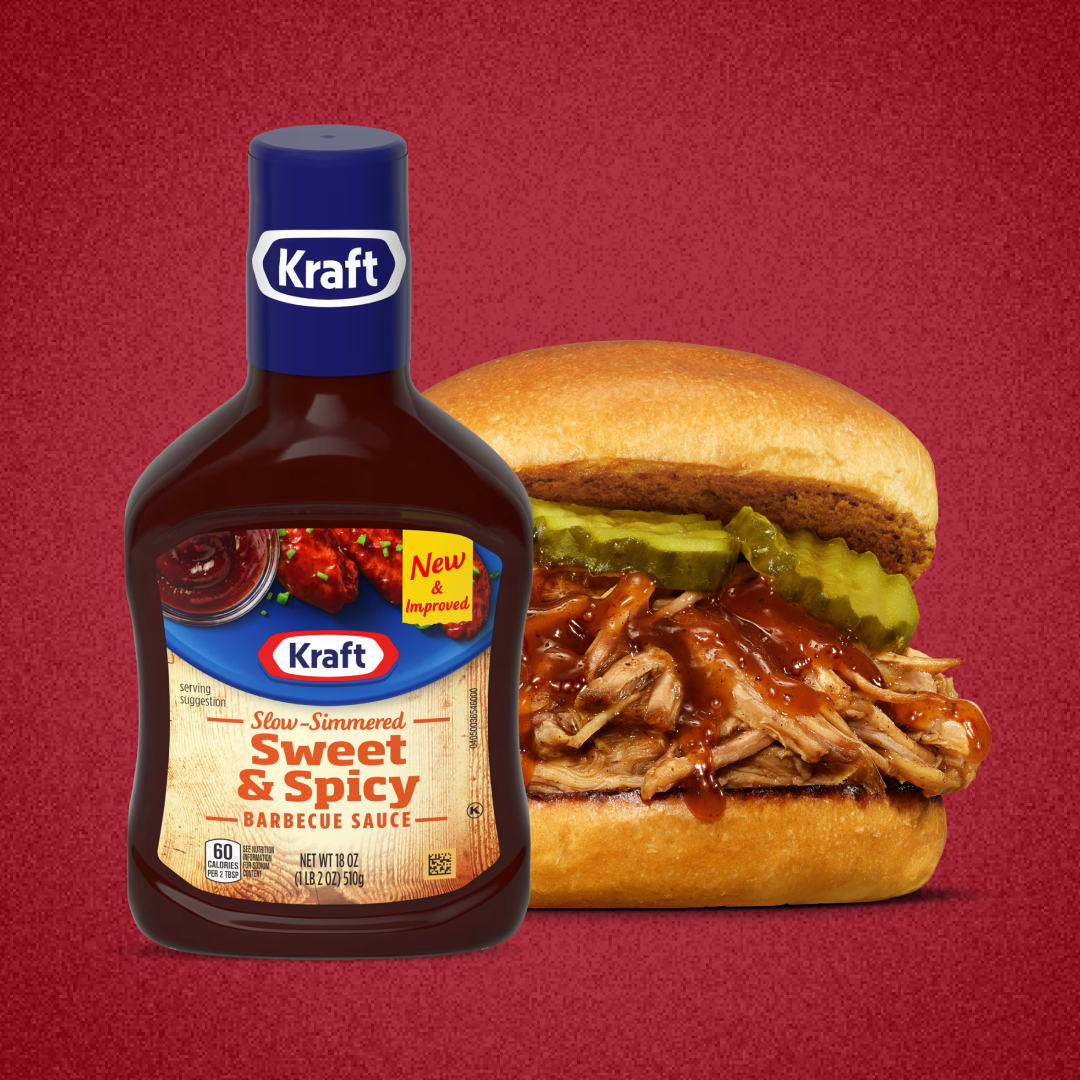 Kraft Sweet & Spicy BBQ Sauce bottle next to a pulled pork sandwich.
