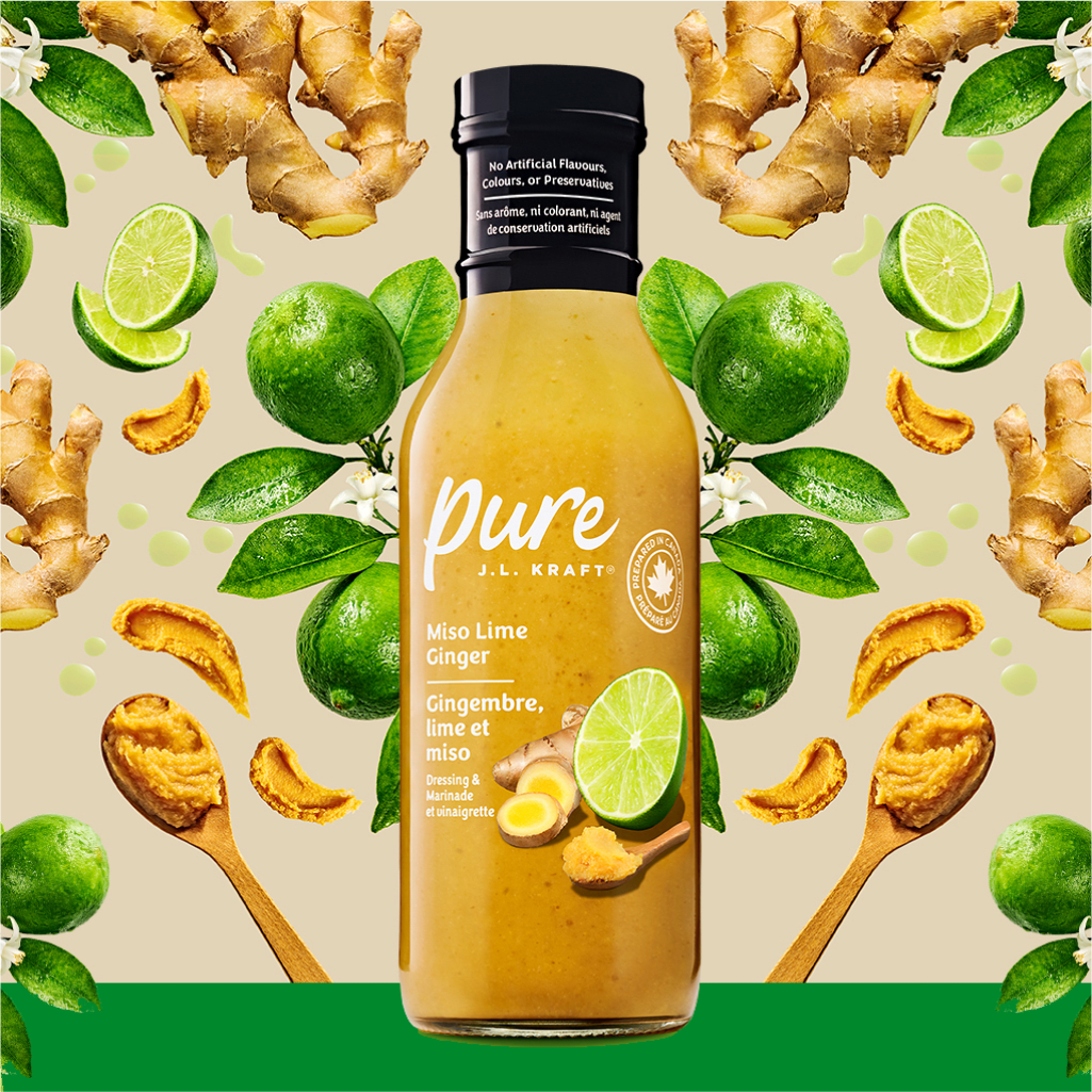 Pure J.L. Kraft Miso Lime Ginger Dressing, surrounded by fresh limes, ginger, and miso paste.