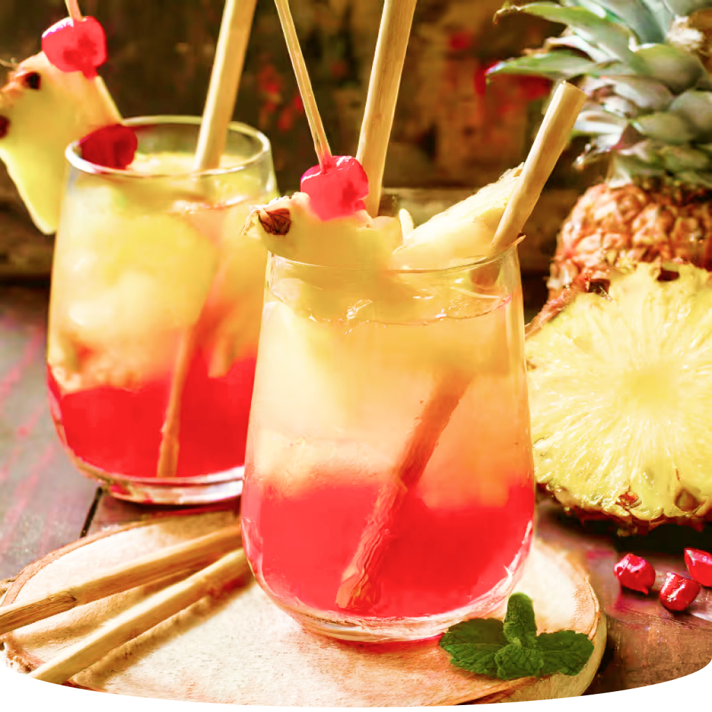 Tropical drinks with pineapple and garnish.