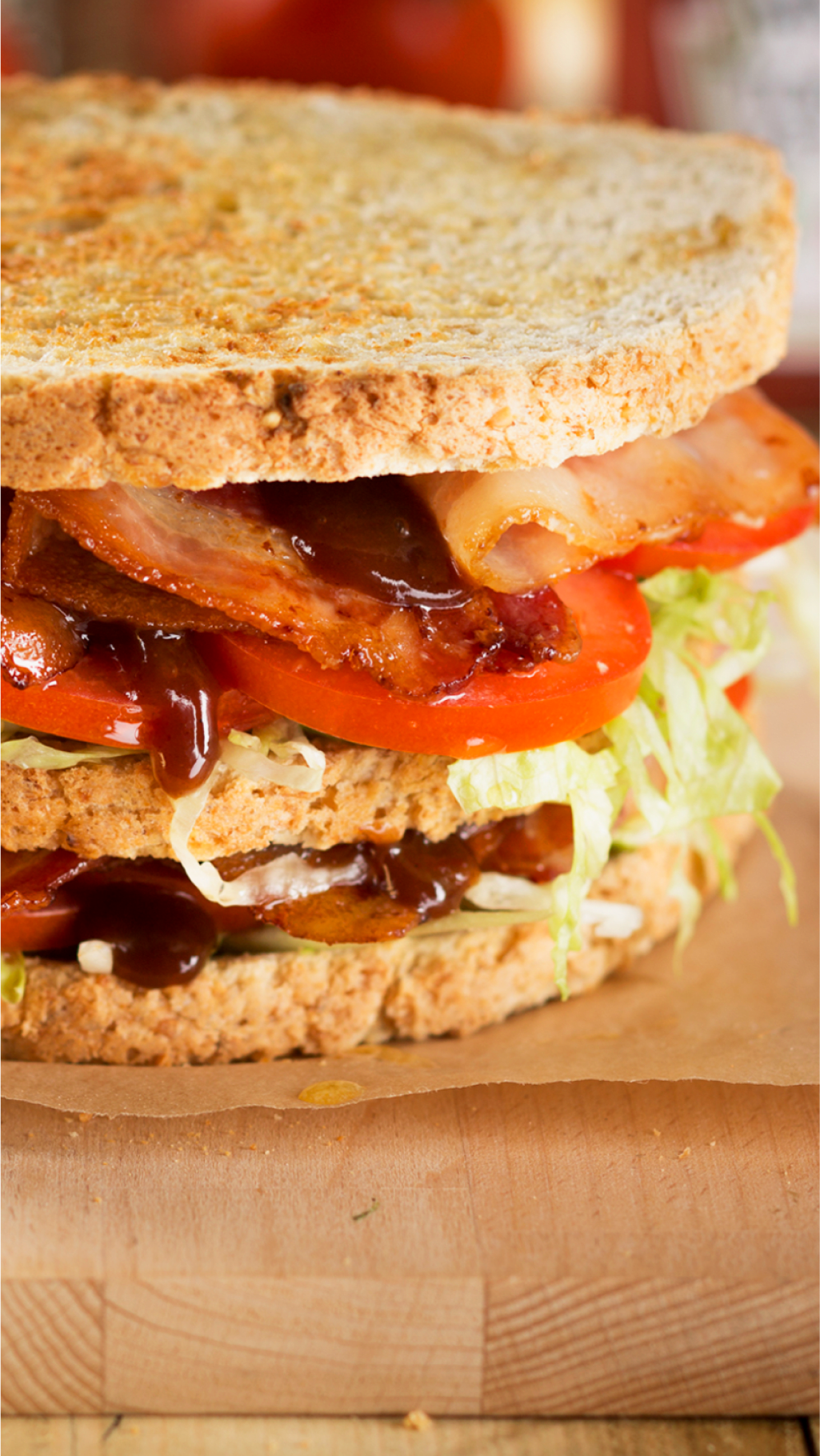 Club sandwich featuring bacon, tomato, lettuce, and dressing.