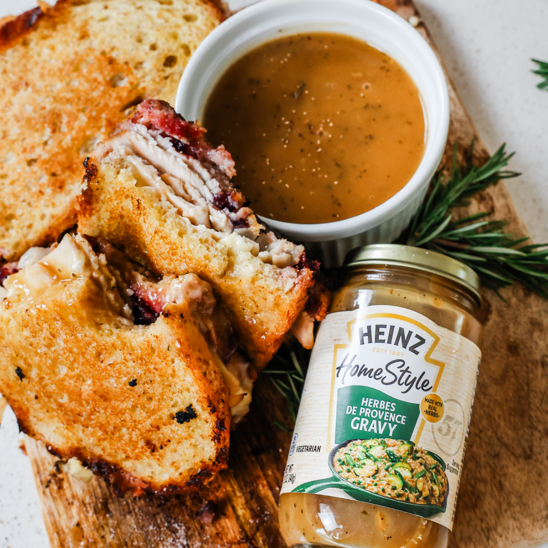 turkey, brie and cranberry sandwich with a jar of Heinz Gravy
