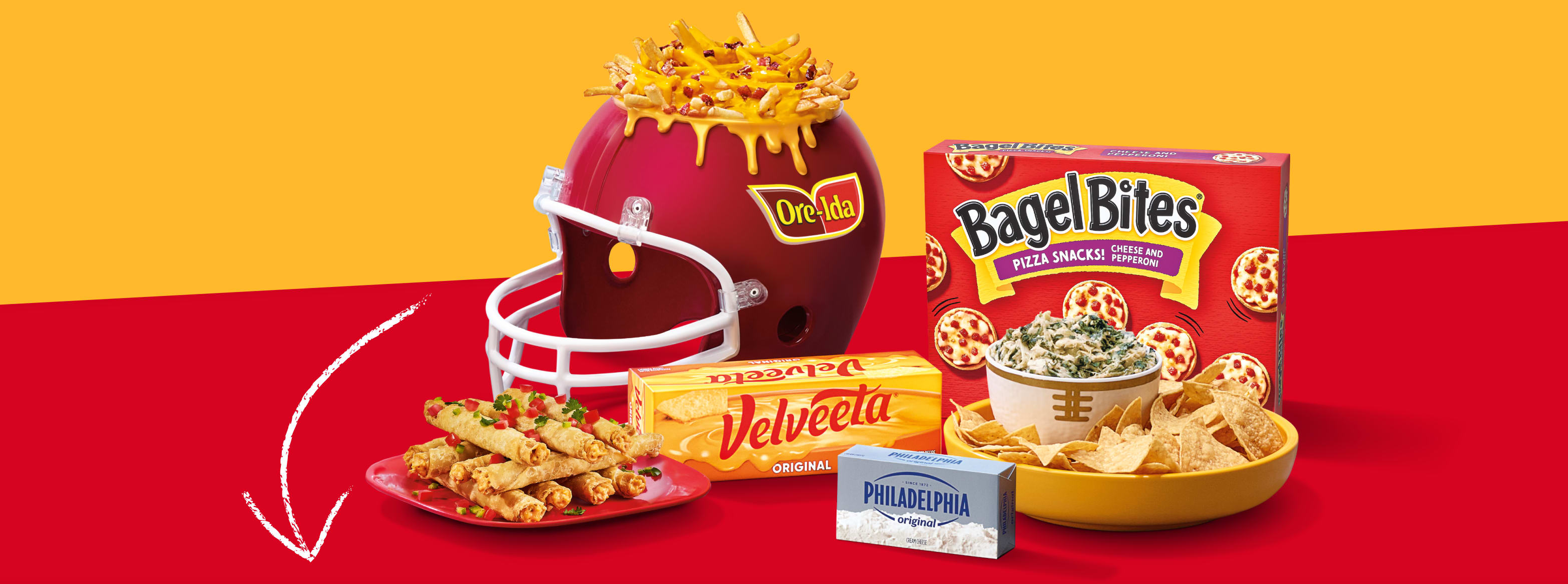 A table with various Kraft Heinz game day snacks: Bagel Bites, wings, taquitos, Ore-Ida fries, dips, ketchup, ranch. 